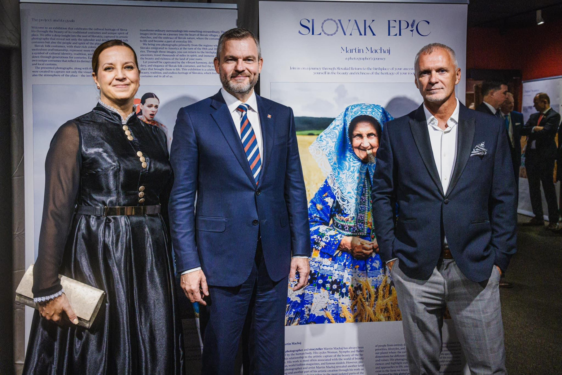Katarína Slobodová Nováková with guests in front of the large Slovak Epic exhibition panel