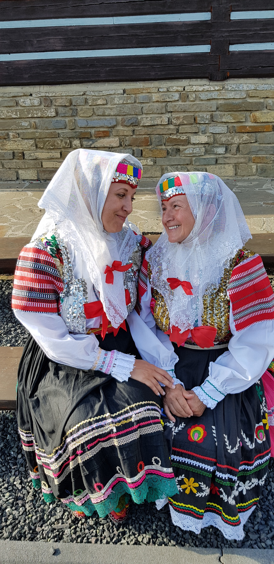 Two women in traditional Slovak folk costume during ethnographic research