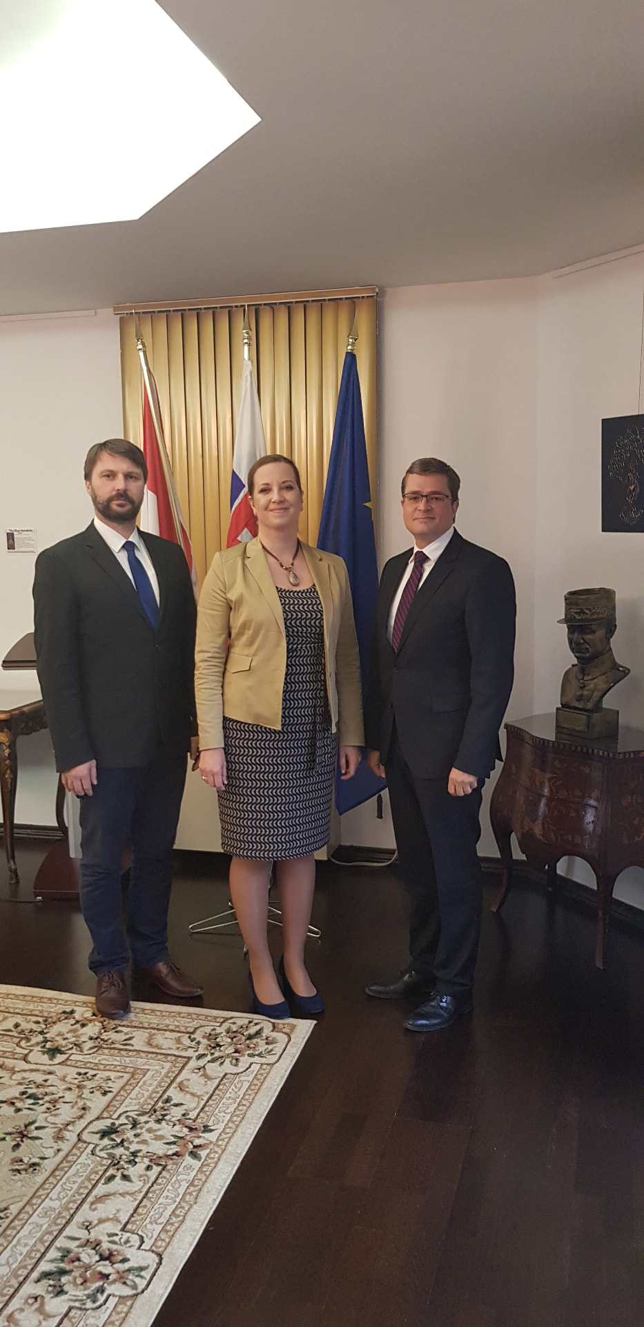Official meeting with Slovak and European flags in the background
